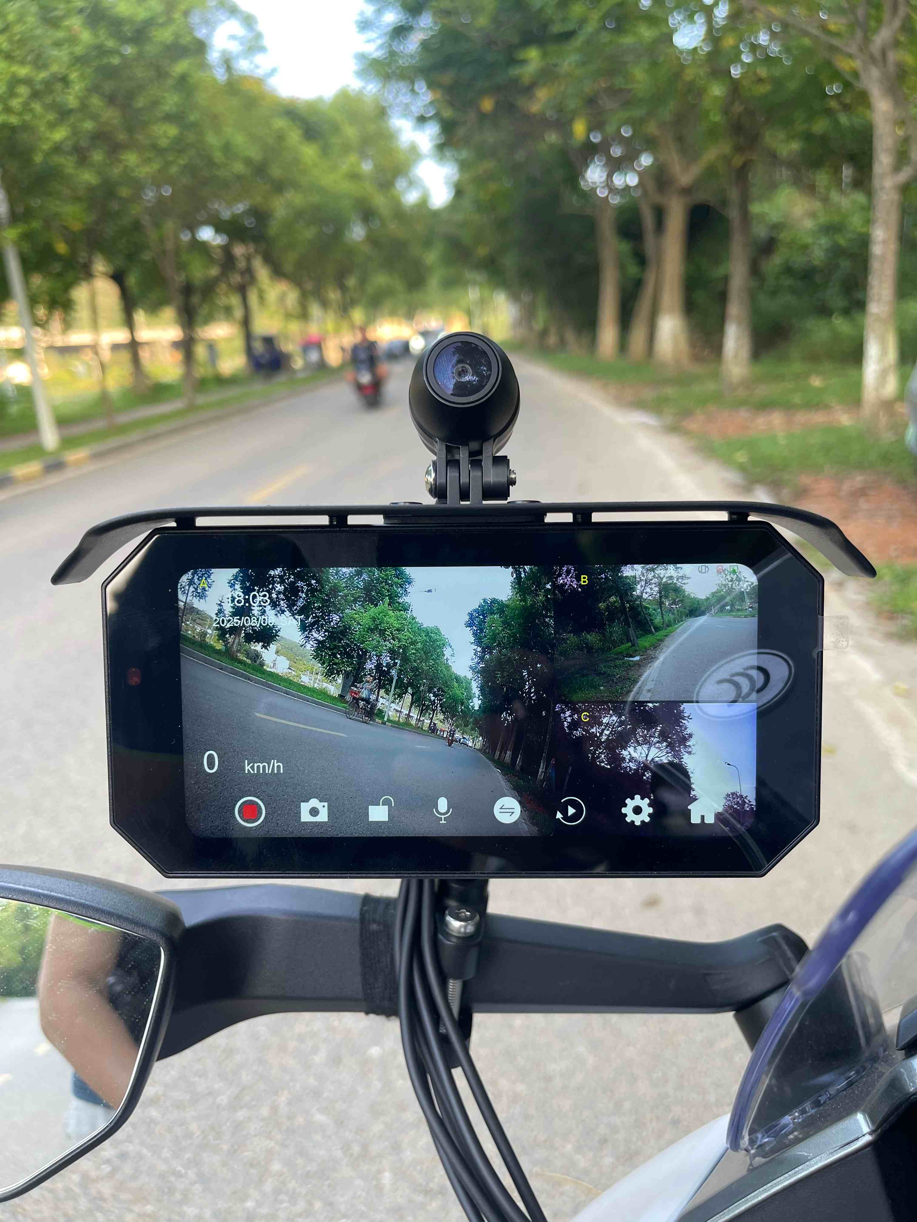 motorcycle dash cam mounted on handlebars capturing real-time road and traffic footage