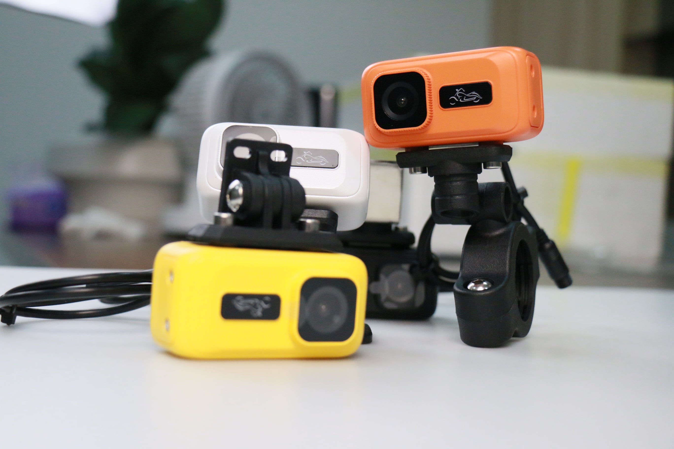 Rider adjusting the angle of the camera motorbike setup before starting a city ride.